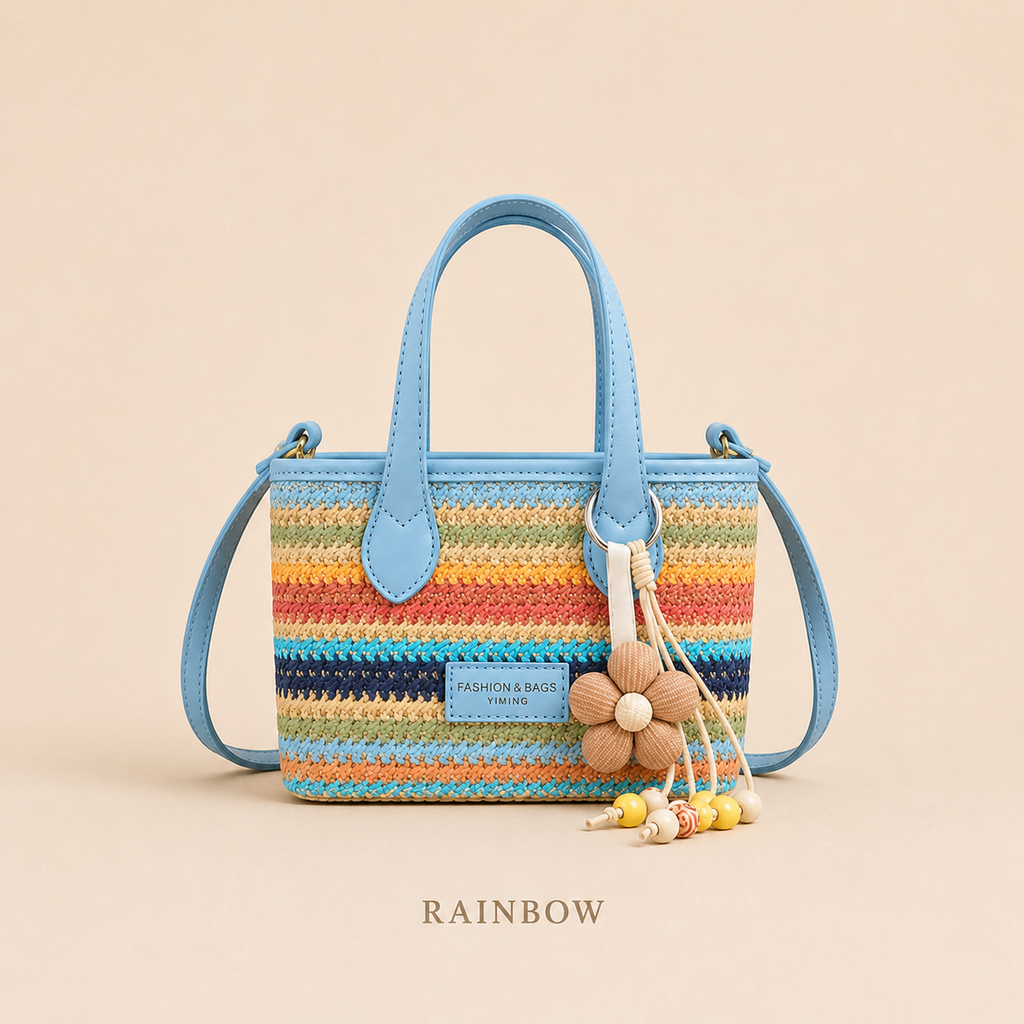 Rainbow woven mini tote crossbody bag with blue handles and flower charm, front view
