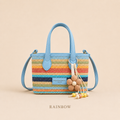 Rainbow woven mini tote crossbody bag with blue handles and flower charm, front view